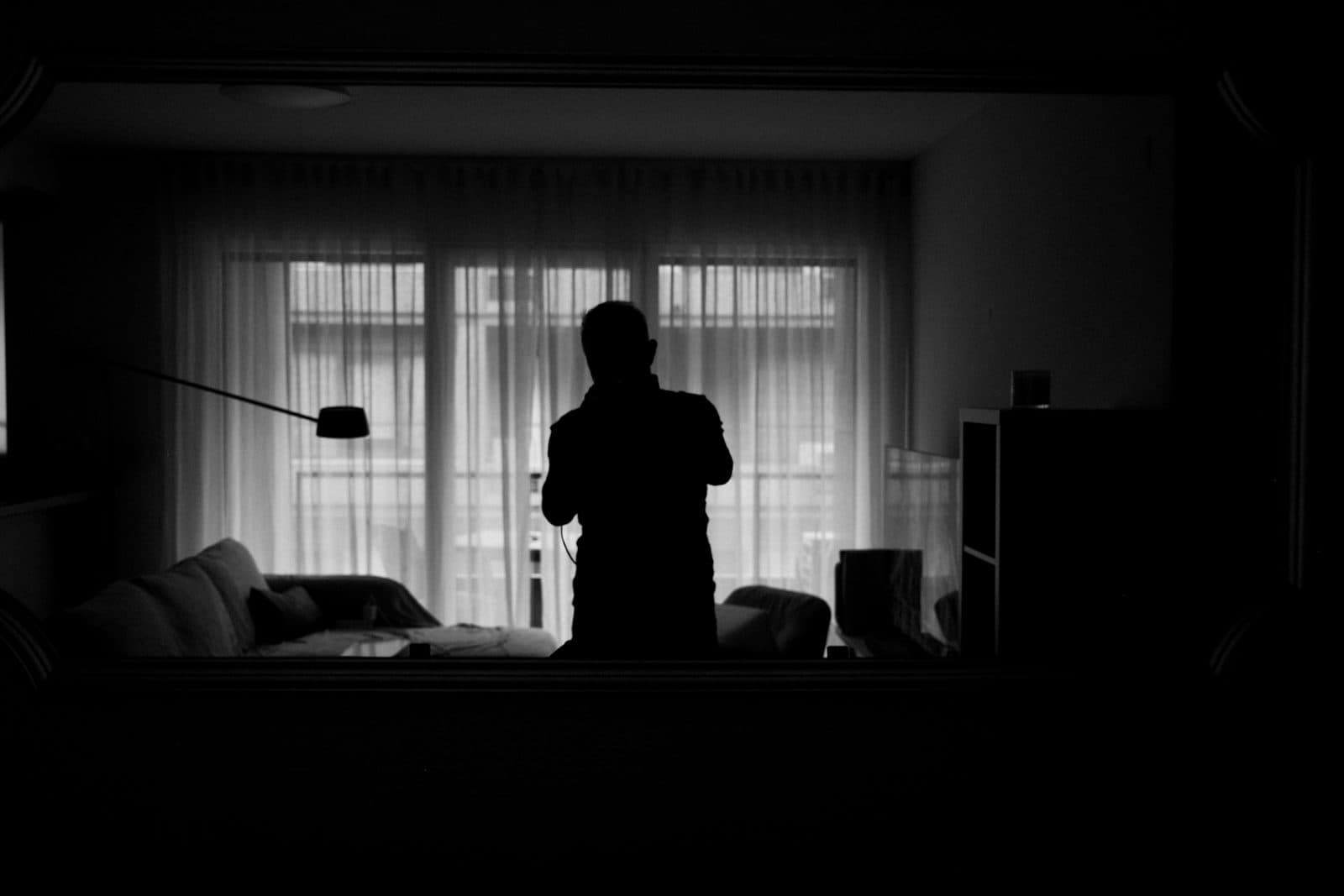 Moiz, photographed against a window at home